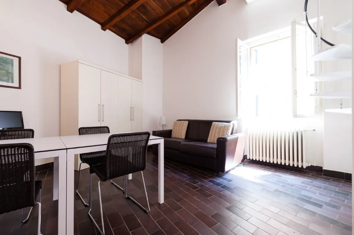 Living room with sofa, dining table and exposed timber ceiling