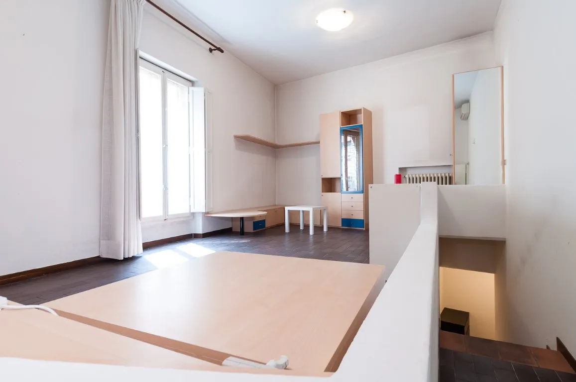 Salón con amplia ventana, baldas en la pared y aire acondicionado